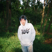 man wearing heather gray james ivy hoodie in forest