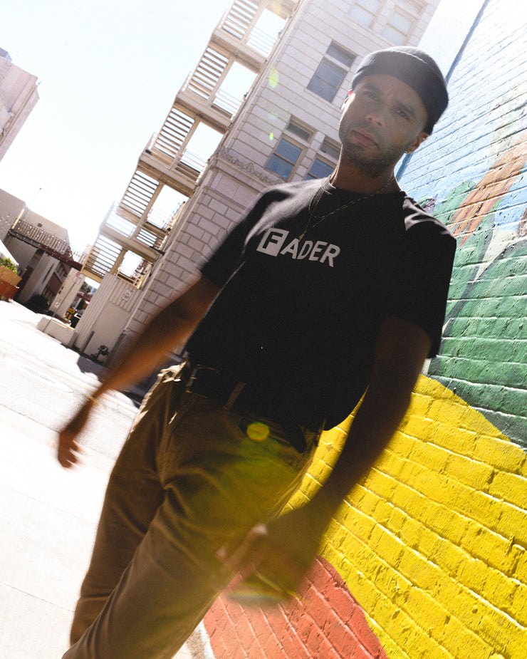 man wearing black t-shirt with the FADER logo