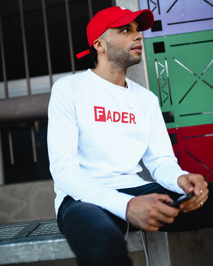 man sitting with white the FADER logo long sleeve on 