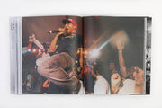 book opened to pages of male artist on stage